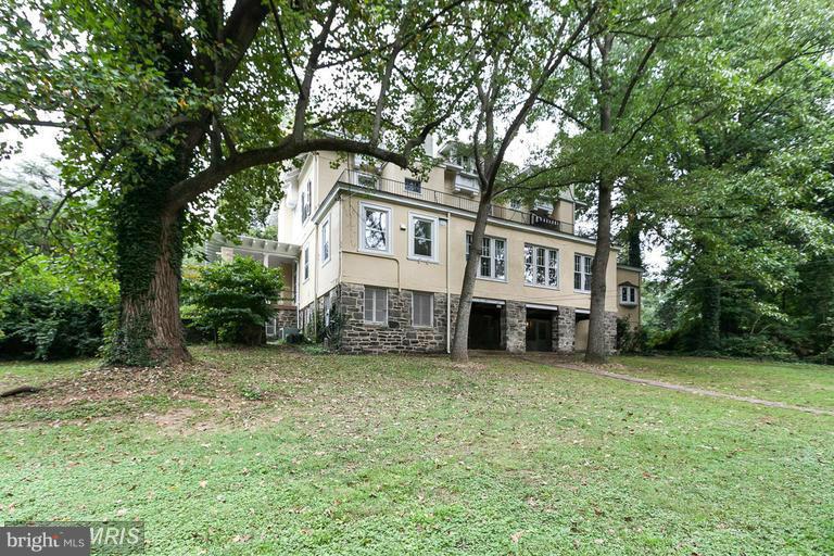 108 Ridgewood Road Baltimore, MD 21210 - Photo 25 of 30 a view of a house with a big yard and large trees