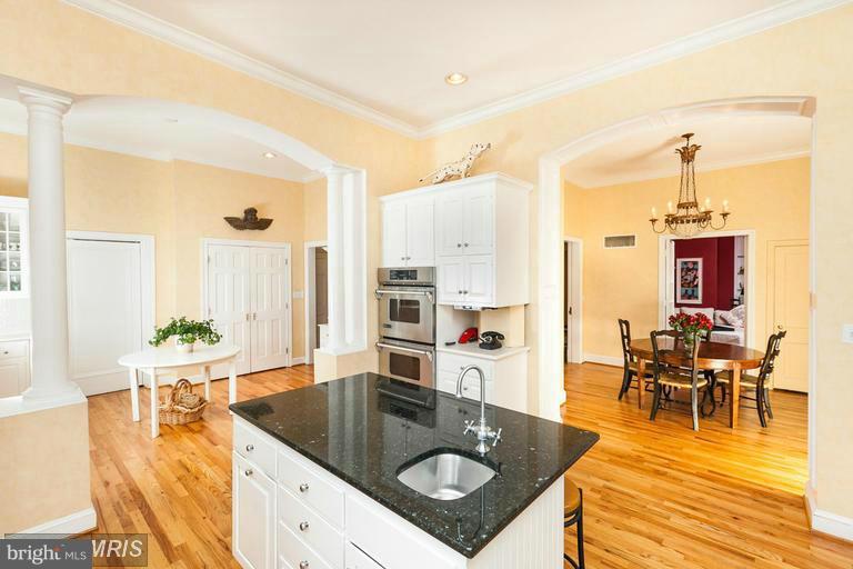 108 Ridgewood Road Baltimore, MD 21210 - Photo 10 of 30 a kitchen with a table chairs and chandelier