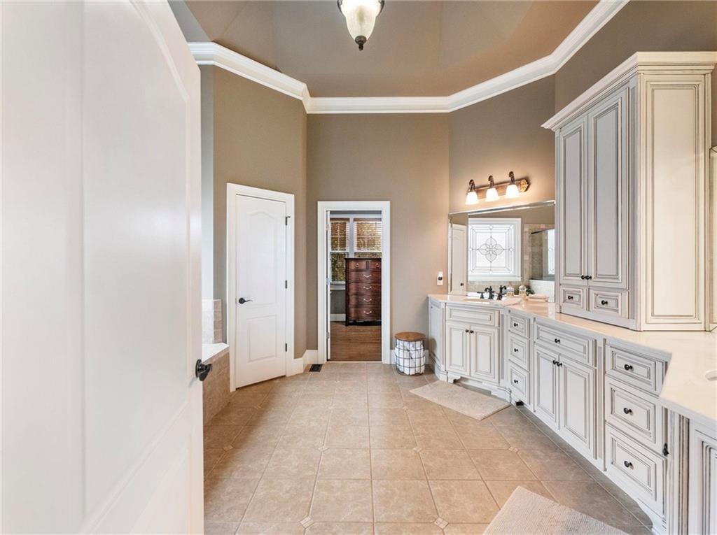 6147 Golf View Court Jefferson, GA 30549 - Photo 24 of 73 a large white kitchen with granite countertop a sink white cabinets and a window