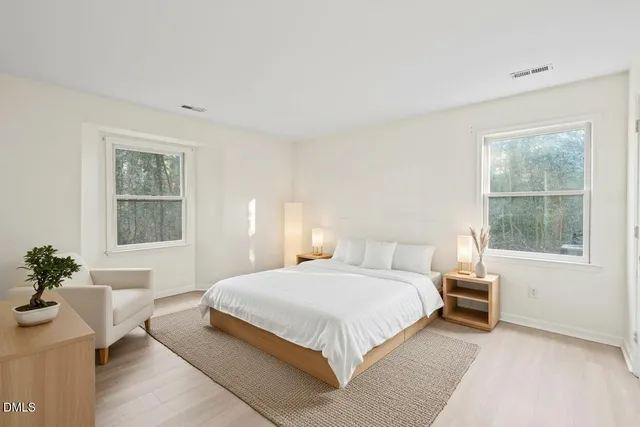 a bedroom with a large bed and a window