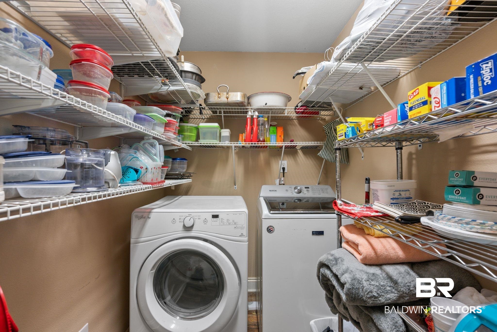 562 Vestige Mews Foley, AL 36535 - Photo 35 of 54 Dedicated utility room featuring a front-load washing machine, top-load washing machine, and extensive wire shelving