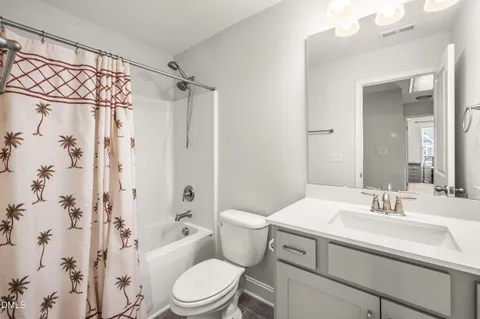 a bedroom with a bed and a flat tv screen on the dresser
