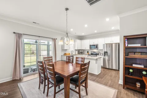 a kitchen with granite countertop a sink a counter top space stainless steel appliances and cabinets