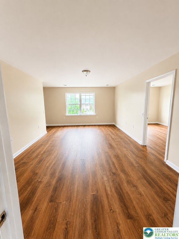 3496 Linden Street, Unit UPPR Bethlehem, PA 18017 - Photo 8 of 9 Rich hardwood-style flooring extends across this spacious, naturally illuminated room, offering an inviting blank canvas.