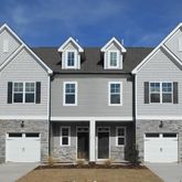 a front view of a residential houses with street