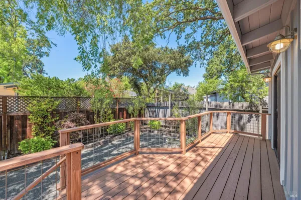 a view of balcony with wooden floor and fence
