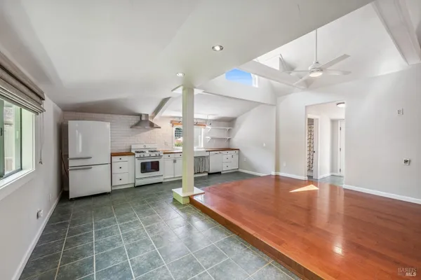 a view of a kitchen with a sink and dishwasher wooden floor