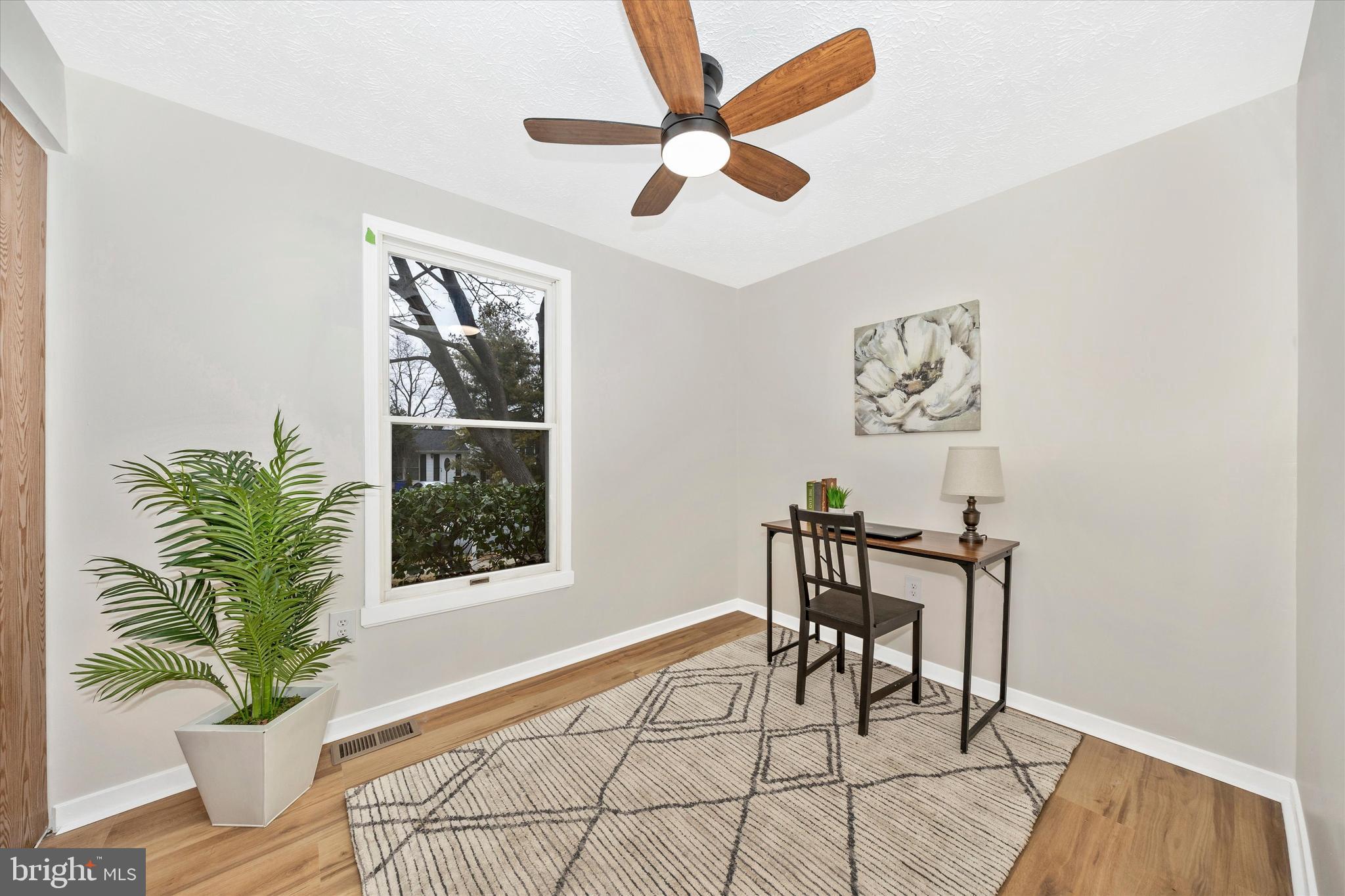 214 Savage Road Frederick, MD 21702 - Photo 12 of 25 a living room with furniture and a potted plant