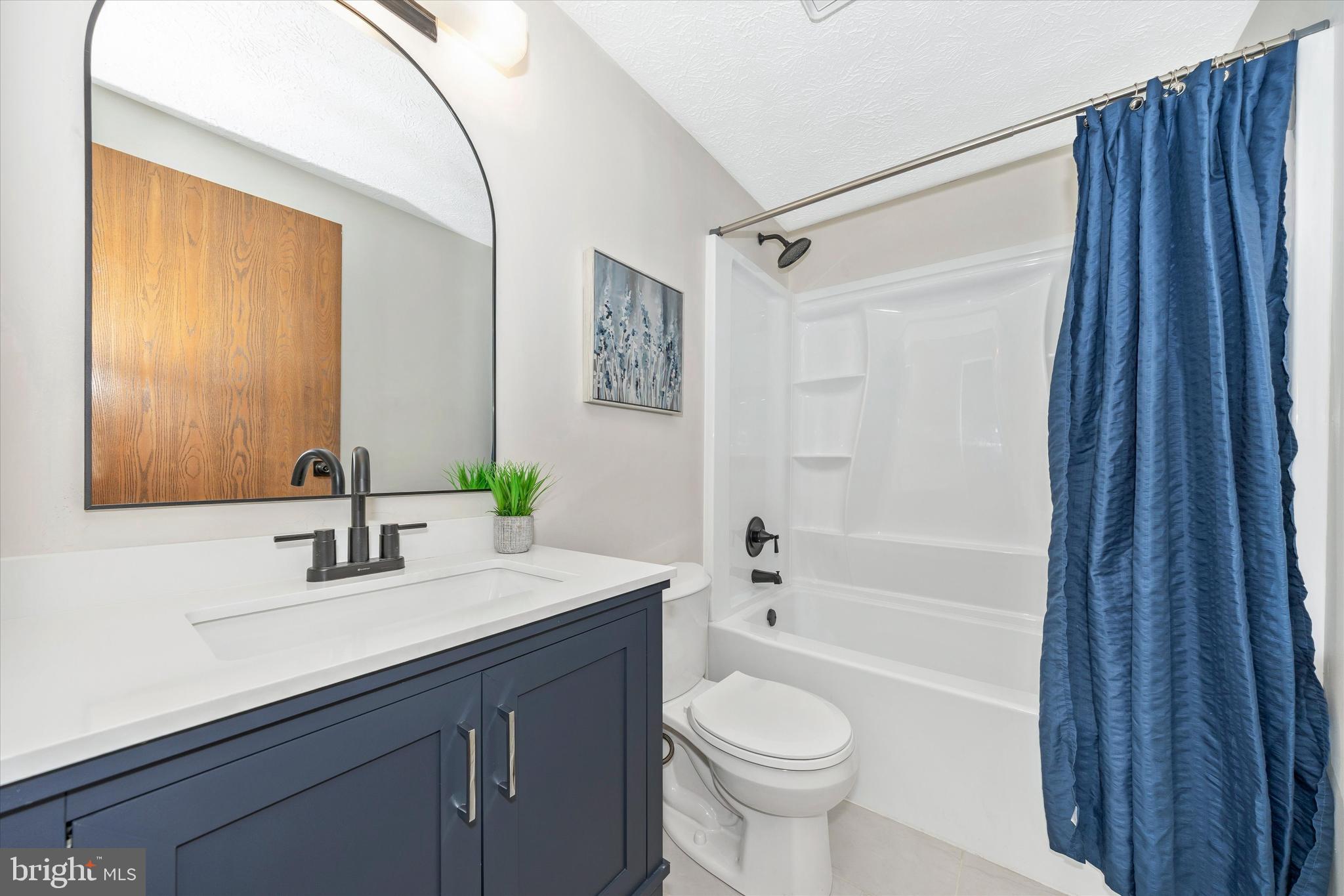 214 Savage Road Frederick, MD 21702 - Photo 14 of 25 a bathroom with a sink a toilet a mirror and shower