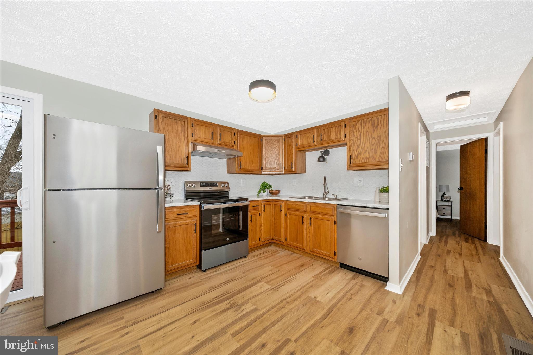 214 Savage Road Frederick, MD 21702 - Photo 4 of 25 a kitchen with stainless steel appliances granite countertop a refrigerator a sink and a stove
