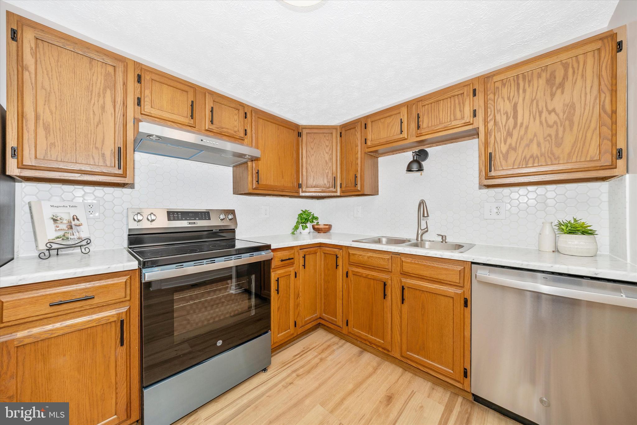 214 Savage Road Frederick, MD 21702 - Photo 5 of 25 a kitchen with a sink stove and cabinets