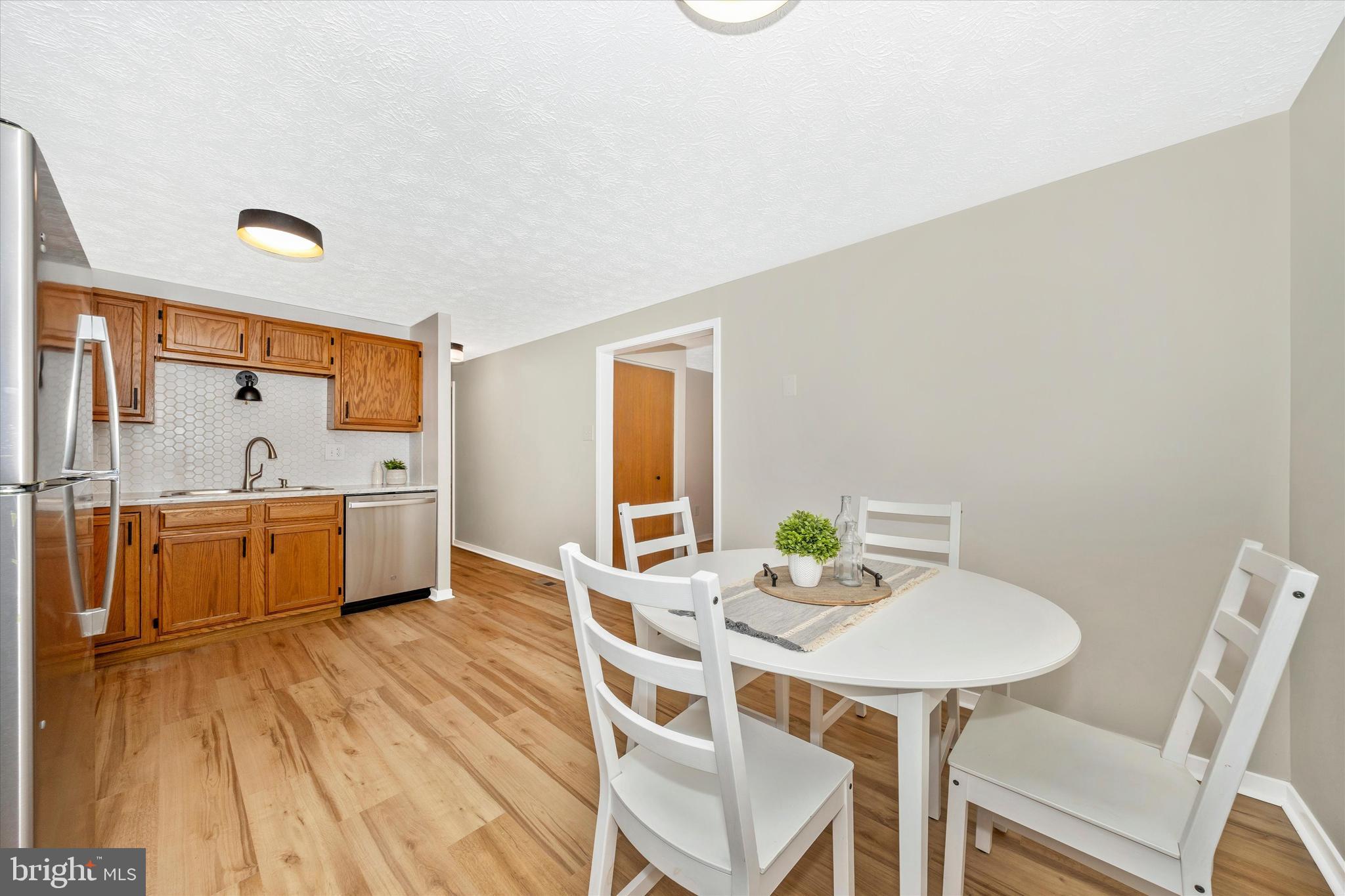 214 Savage Road Frederick, MD 21702 - Photo 6 of 25 a kitchen with a table and chairs
