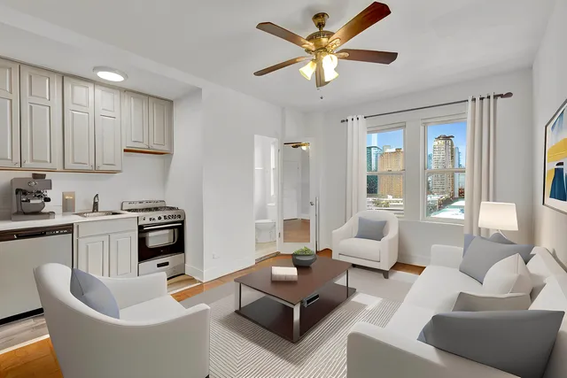a living room with furniture and a kitchen