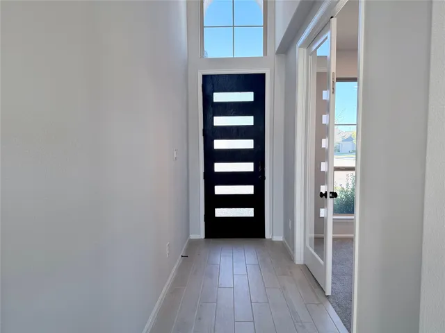 wooden floor in a room with a large window
