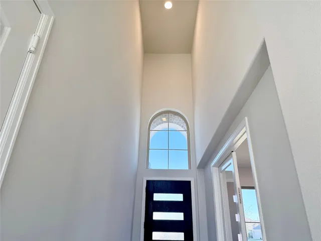 a view of a hallway with wooden floor and entryway
