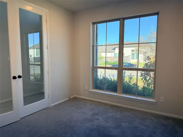 an empty room with windows and closet