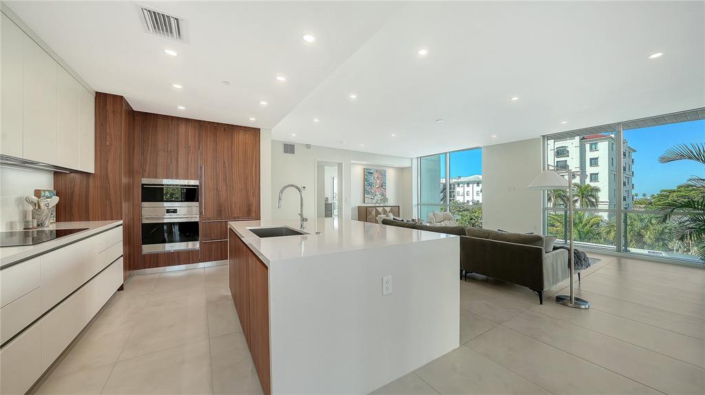111 Golden Gate Point, Unit 201 Sarasota, FL 34236 - Photo 16 of 64 a large kitchen with stainless steel appliances granite countertop a large counter top a stove and a refrigerator