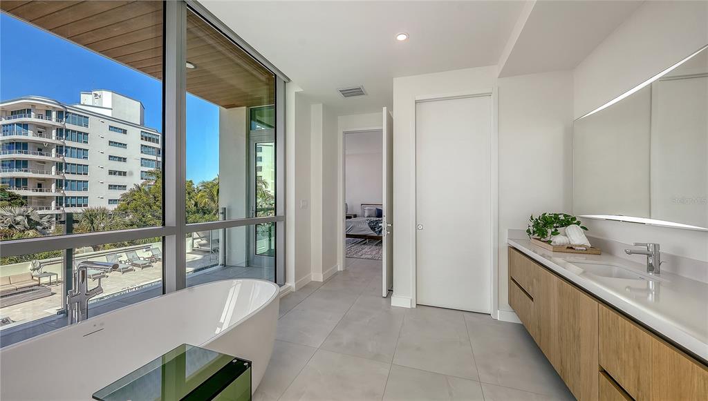 111 Golden Gate Point, Unit 201 Sarasota, FL 34236 - Photo 25 of 64 a large bathroom with a tub and shower