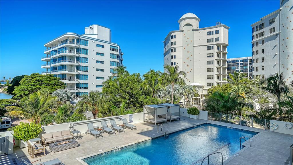 111 Golden Gate Point, Unit 201 Sarasota, FL 34236 - Photo 37 of 64 a front view of multi story residential apartment building with yard and outdoor space