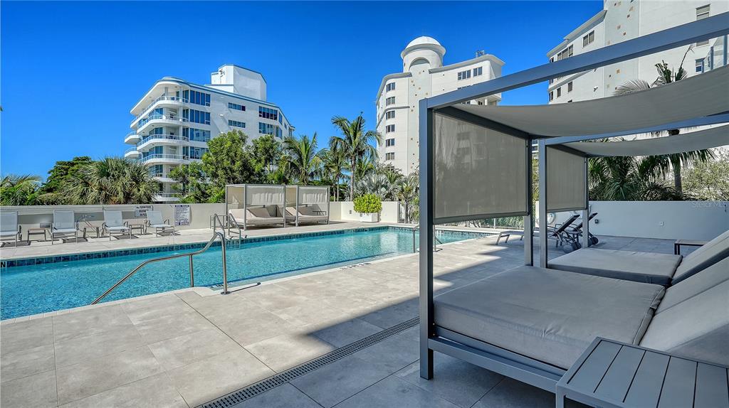 111 Golden Gate Point, Unit 201 Sarasota, FL 34236 - Photo 39 of 64 a view of a patio with table and chairs potted plants