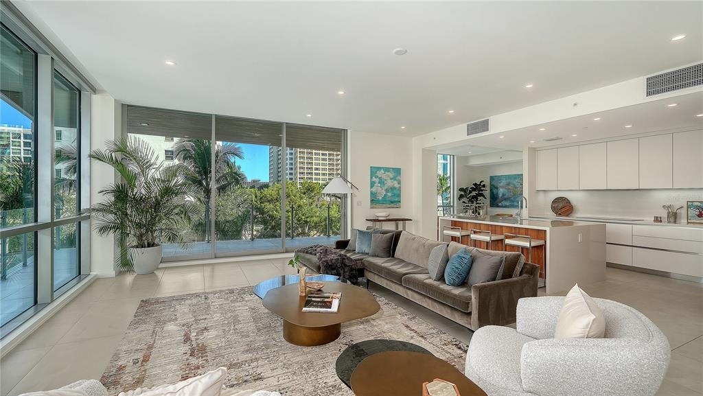 111 Golden Gate Point, Unit 201 Sarasota, FL 34236 - Photo 5 of 64 a living room with furniture and a large window