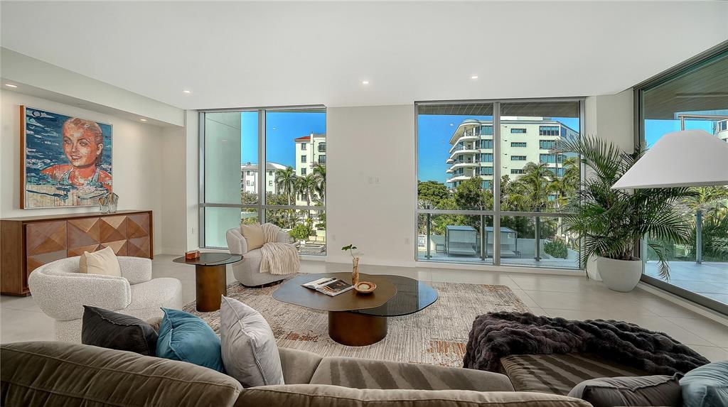 111 Golden Gate Point, Unit 201 Sarasota, FL 34236 - Photo 7 of 64 a living room with furniture and a large window