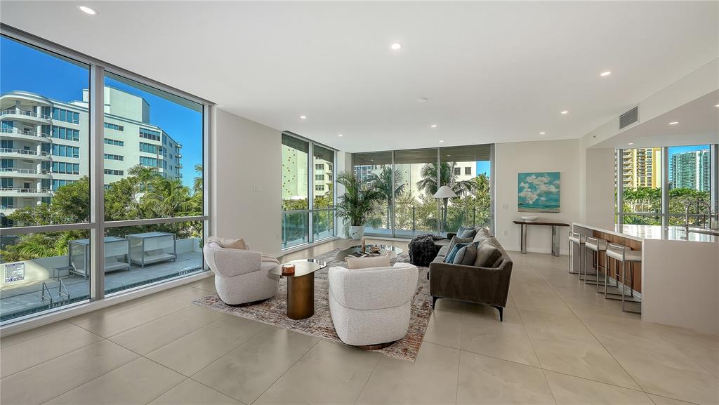 111 Golden Gate Point, Unit 201 Sarasota, FL 34236 - Photo 8 of 64 a living room with furniture and a large window