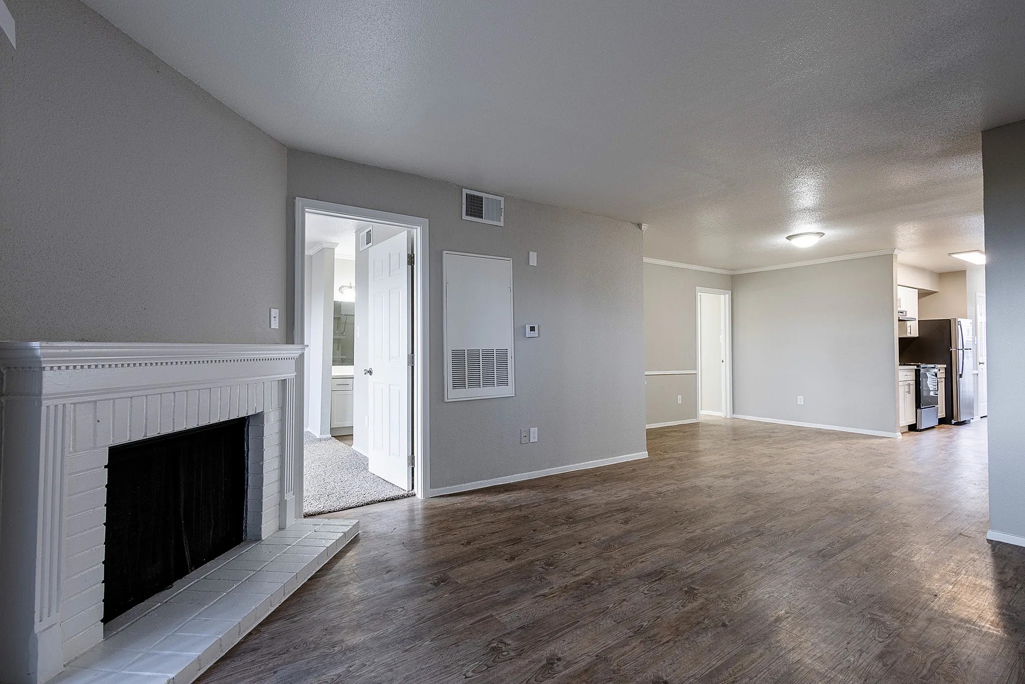 1230 Farm To Market 1960 Bypass Road East, Unit 802 Humble, TX 77338 - Photo 6 of 20 a view of an empty room with wooden floor and a fireplace