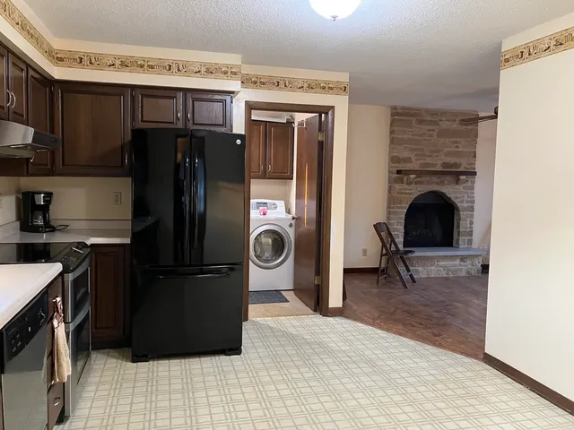 a kitchen with a refrigerator and a stove