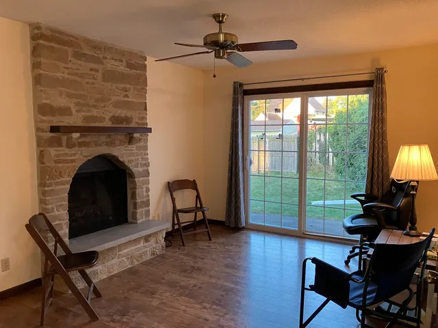 a living room with furniture and a fireplace