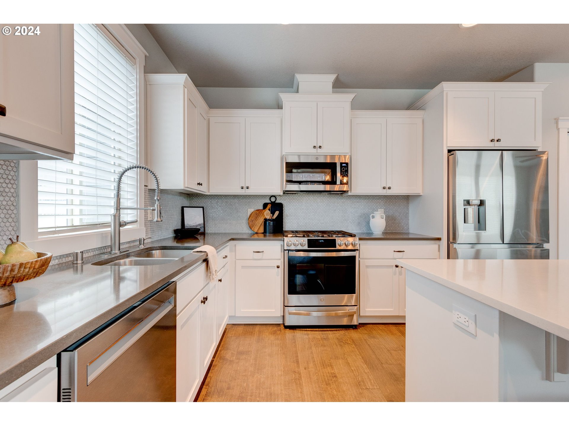 3293 North 10th Street Ridgefield, WA 98642 - Photo 19 of 47 a kitchen with stainless steel appliances granite countertop a sink stove refrigerator and cabinets