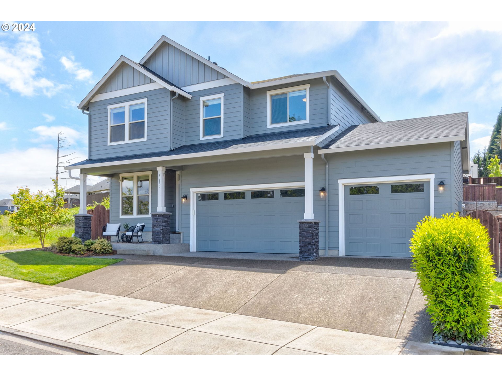 3293 North 10th Street Ridgefield, WA 98642 - Photo 2 of 47 a front view of a house with a yard and garage