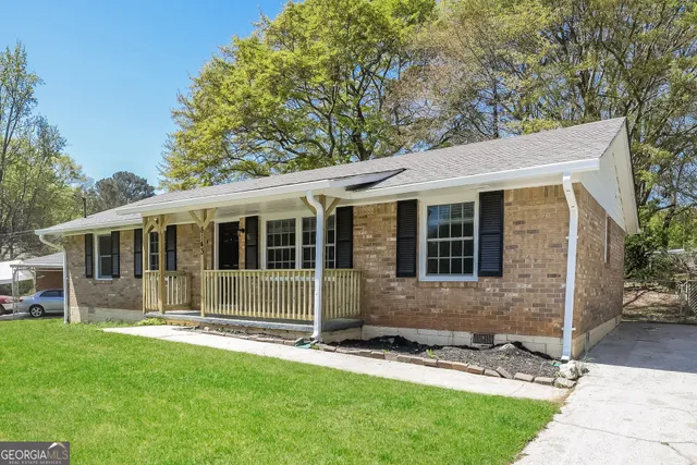 a front view of a house with a garden