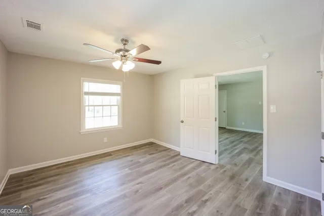 wooden floor in an empty room with a window