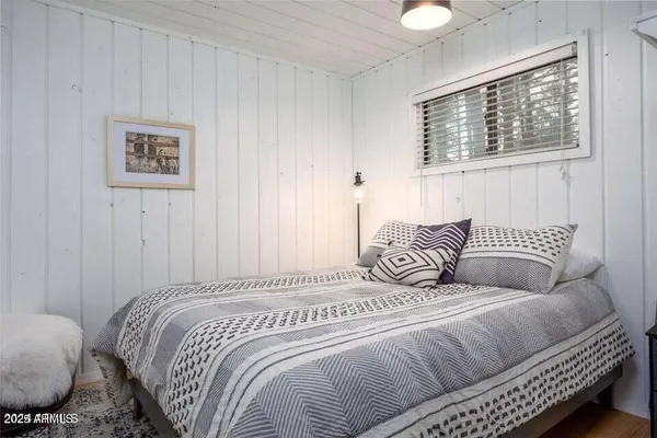 a bedroom with bed and a window