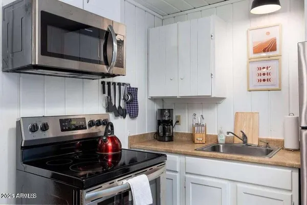 a kitchen with stainless steel appliances granite countertop a stove and a microwave