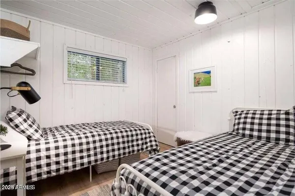 a bedroom with a bed and painting on the wall