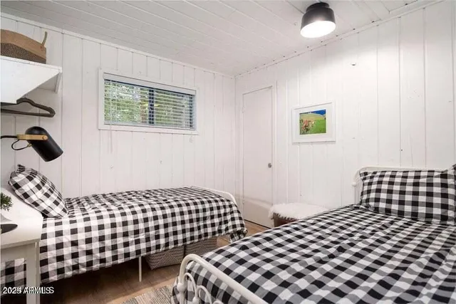 a bedroom with a bed and painting on the wall