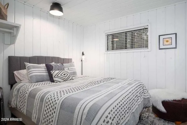 a bedroom with a bed and a couch