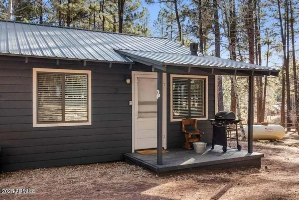 a view of a patio with a table and chairs