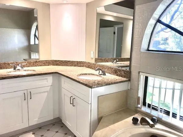 a bathroom with a granite countertop sink a mirror and a