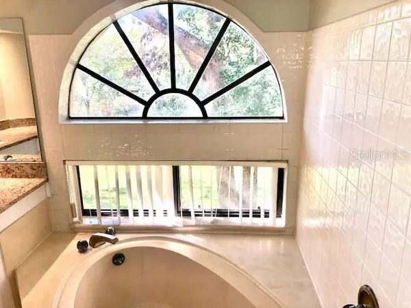 a view of a livingroom with wooden floor and a window