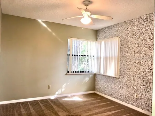 a view of bathroom with a sink and mirror
