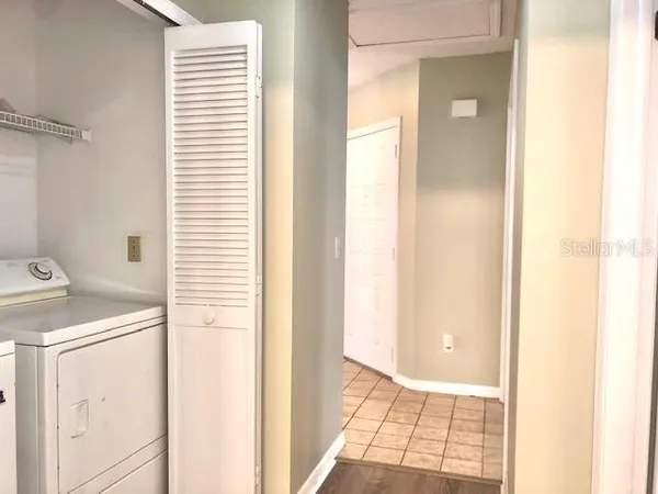 an empty room with a window and wooden floor