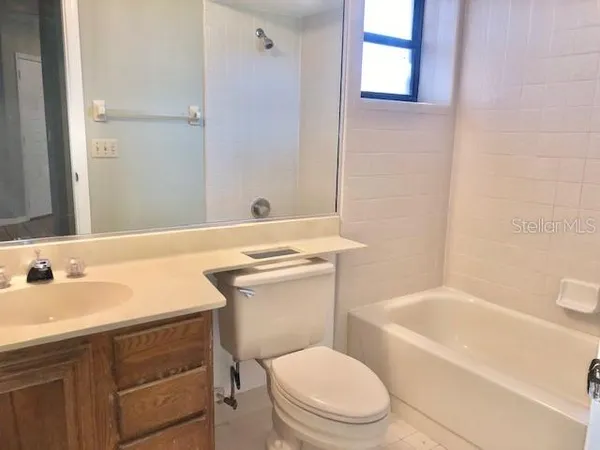 a view of a big room with wooden floor and a ceiling fan