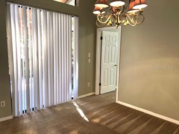 a view of a livingroom with a ceiling fan and window