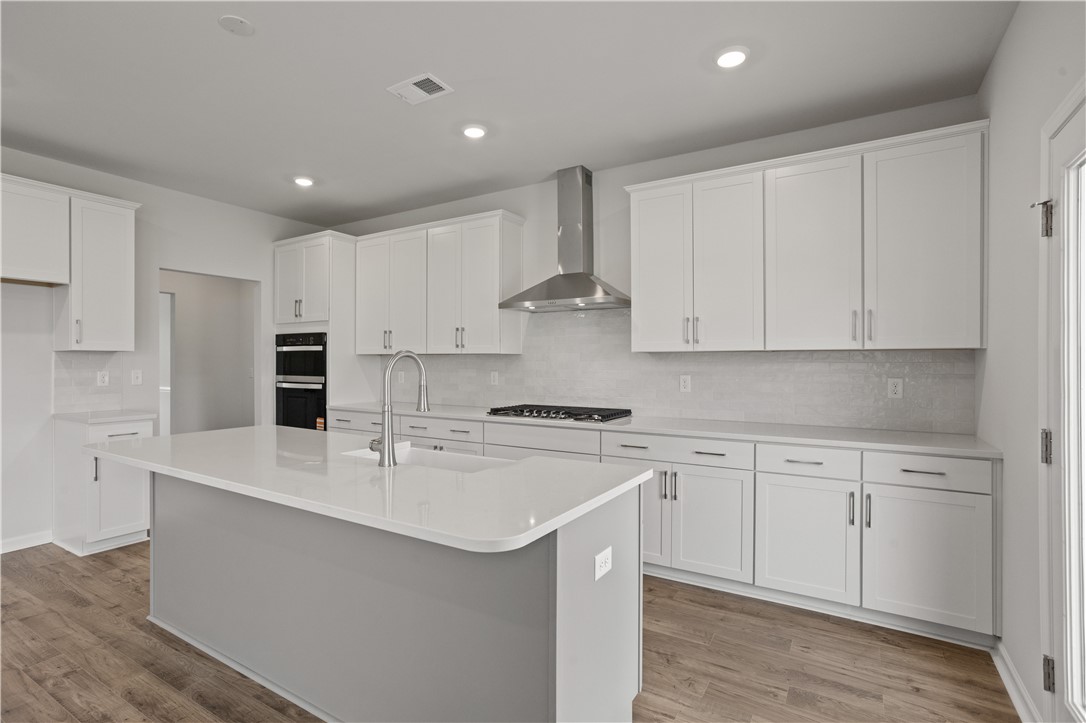 555 Hydrangea Street, Unit LOT 47 Seneca, SC 29678 - Photo 12 of 38 Culinary dreams come alive in this kitchen featuring abundant white cabinetry and a spacious island.