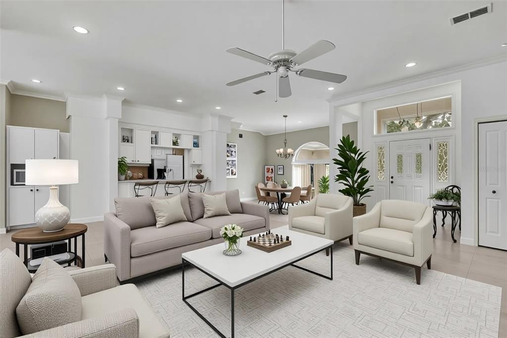 3275 West Daffodil Drive Dunnellon, FL 34433 - Photo 18 of 67 a living room with furniture and a chandelier