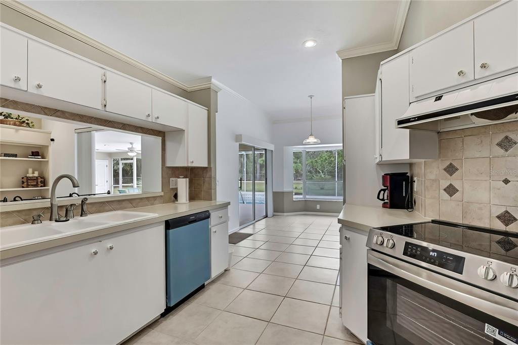 3275 West Daffodil Drive Dunnellon, FL 34433 - Photo 24 of 67 a kitchen with stainless steel appliances granite countertop a sink stove and cabinets