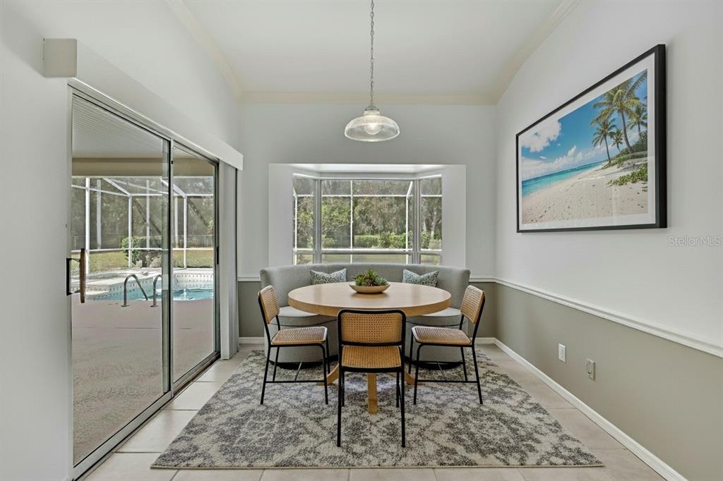 3275 West Daffodil Drive Dunnellon, FL 34433 - Photo 26 of 67 a dining room with furniture a rug and a large window